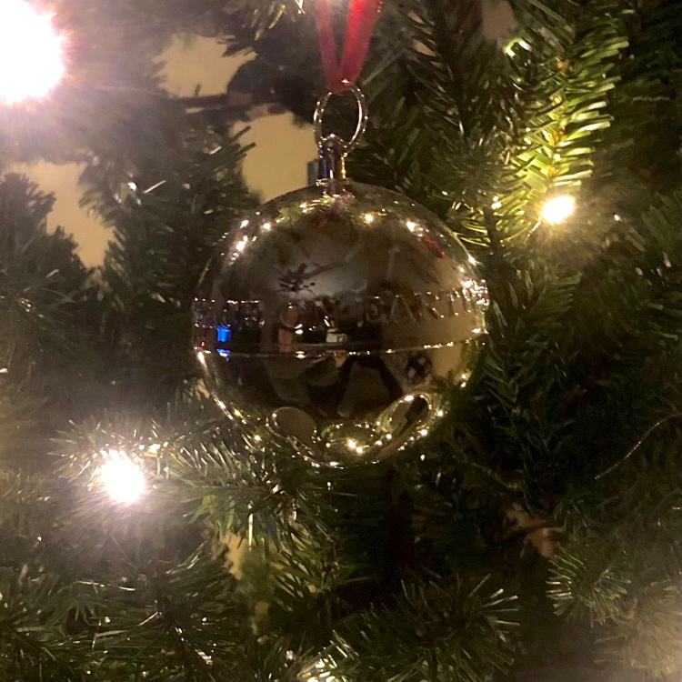 Silver Bell Christmas Ornament on a Christmas Tree