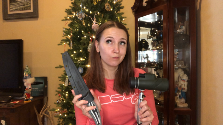 jessica in front of a christmas tree with a fishing knife and monocular